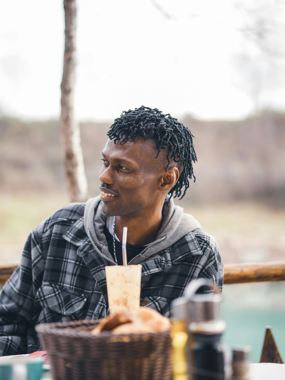 a man sitting at a table with a basket of food