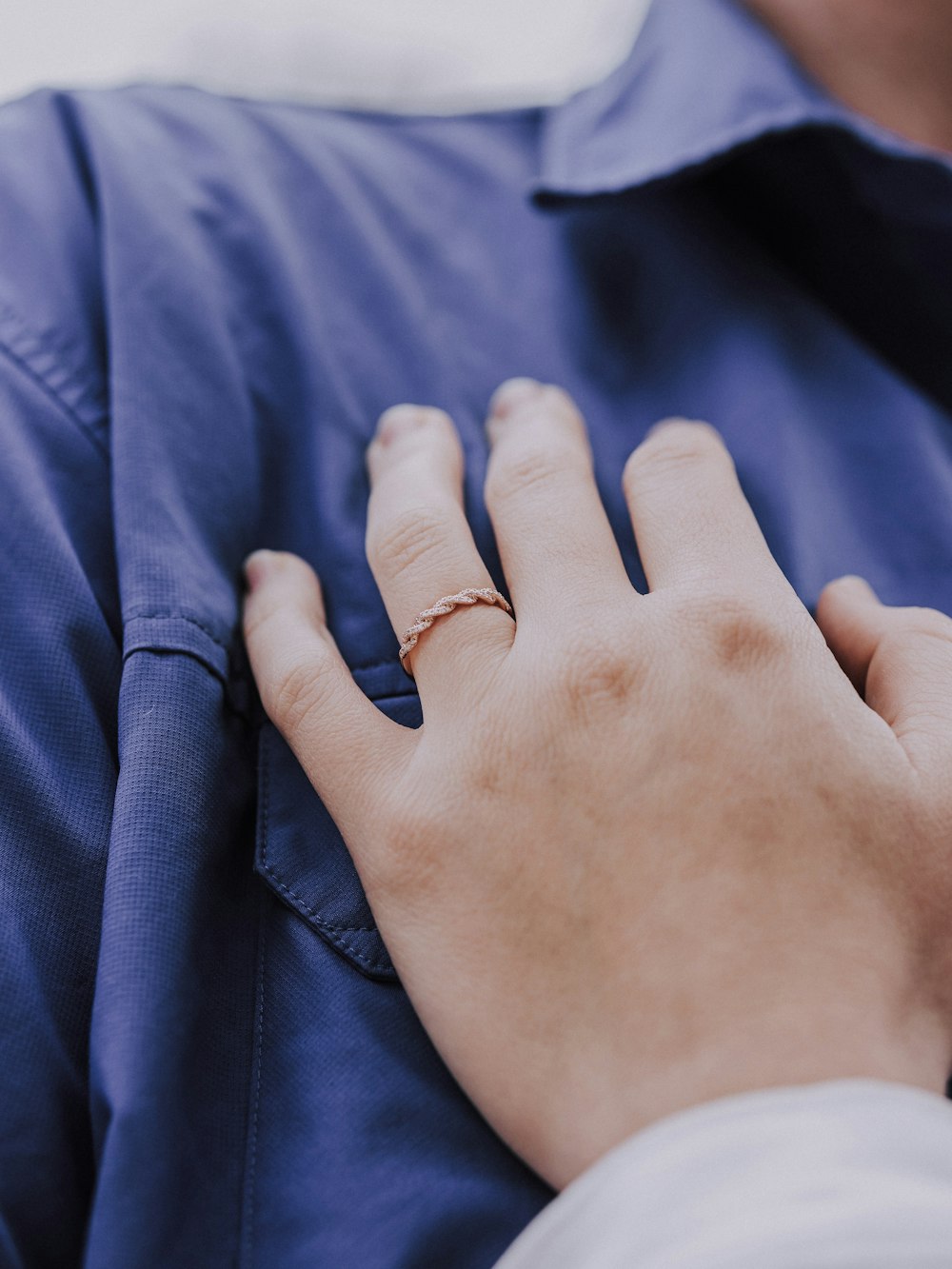 a person wearing a ring on their left hand