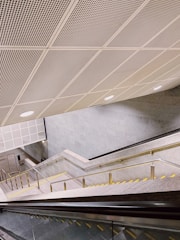 Detailed view of metal staircases with safety railings installed in a building.
