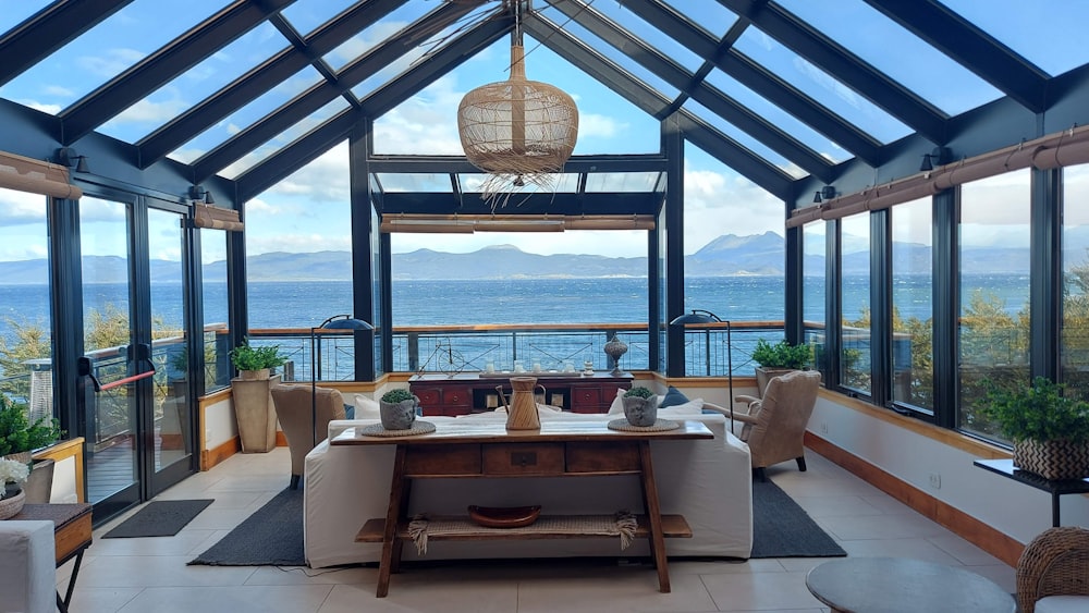 a living room filled with furniture and a view of the ocean