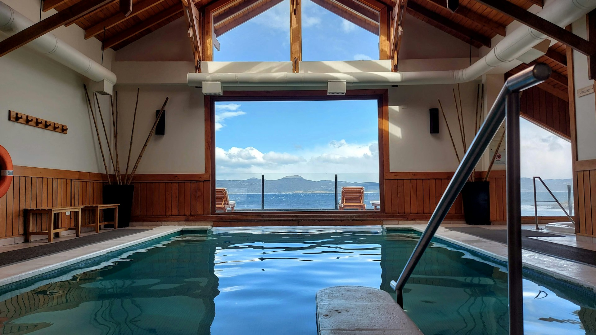 a large indoor swimming pool with a view of the ocean