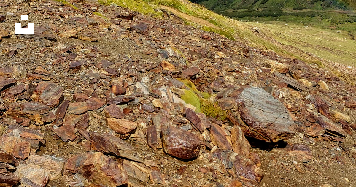 A mountain with a few rocks on the ground photo – Free Natural park ...