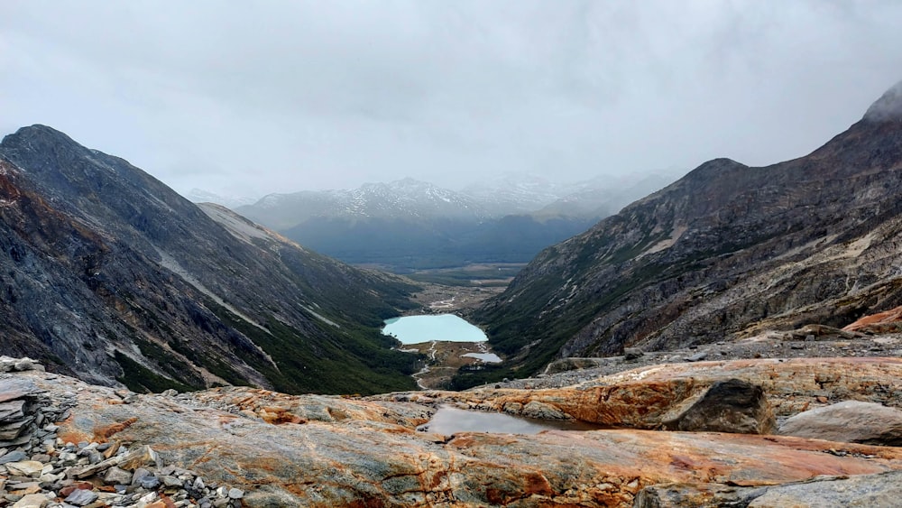 a view of a lake in the middle of a mountain range