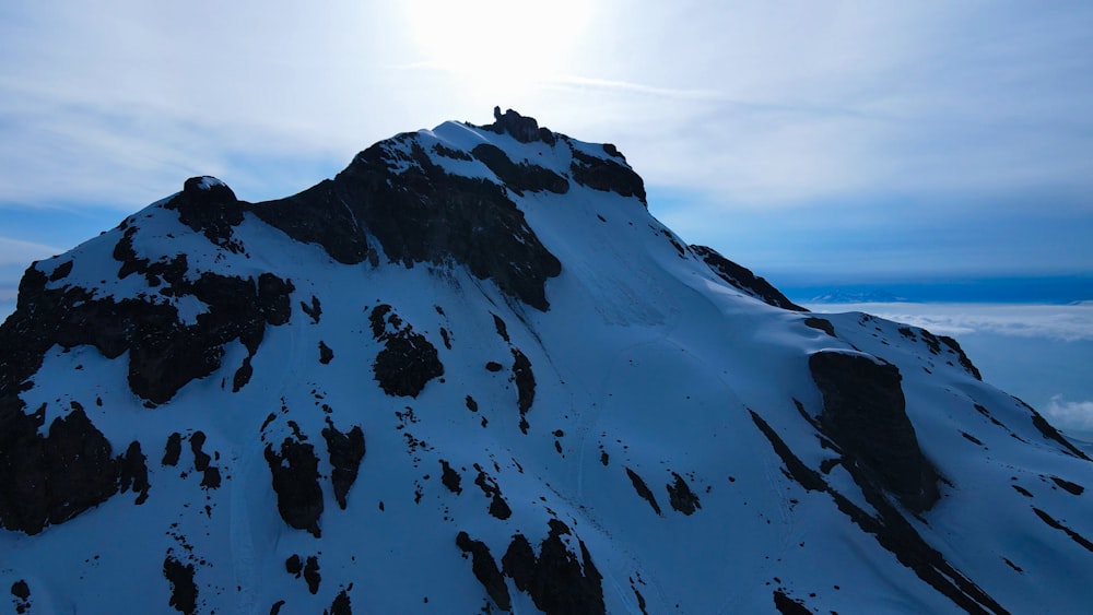 a mountain covered in snow under a blue sky