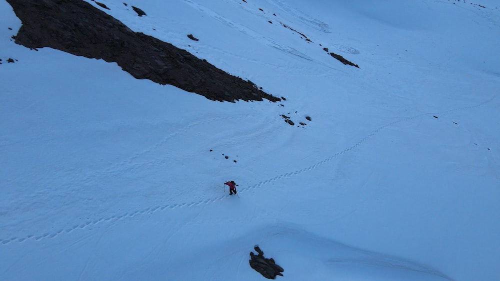 a person is skiing down a snowy mountain