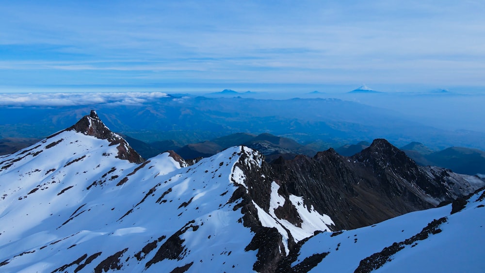 a view of a mountain range covered in snow