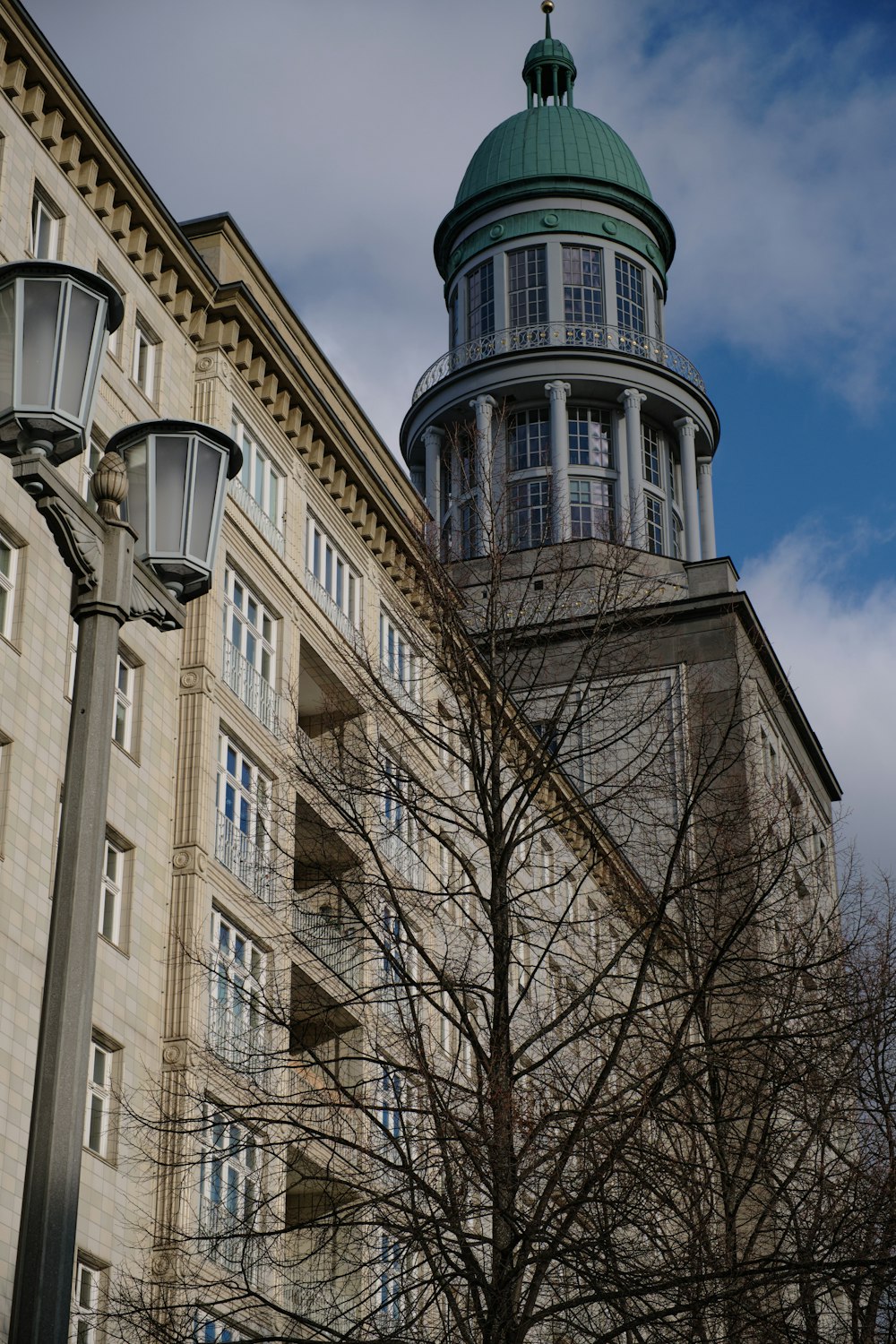 a tall building with a green dome on top