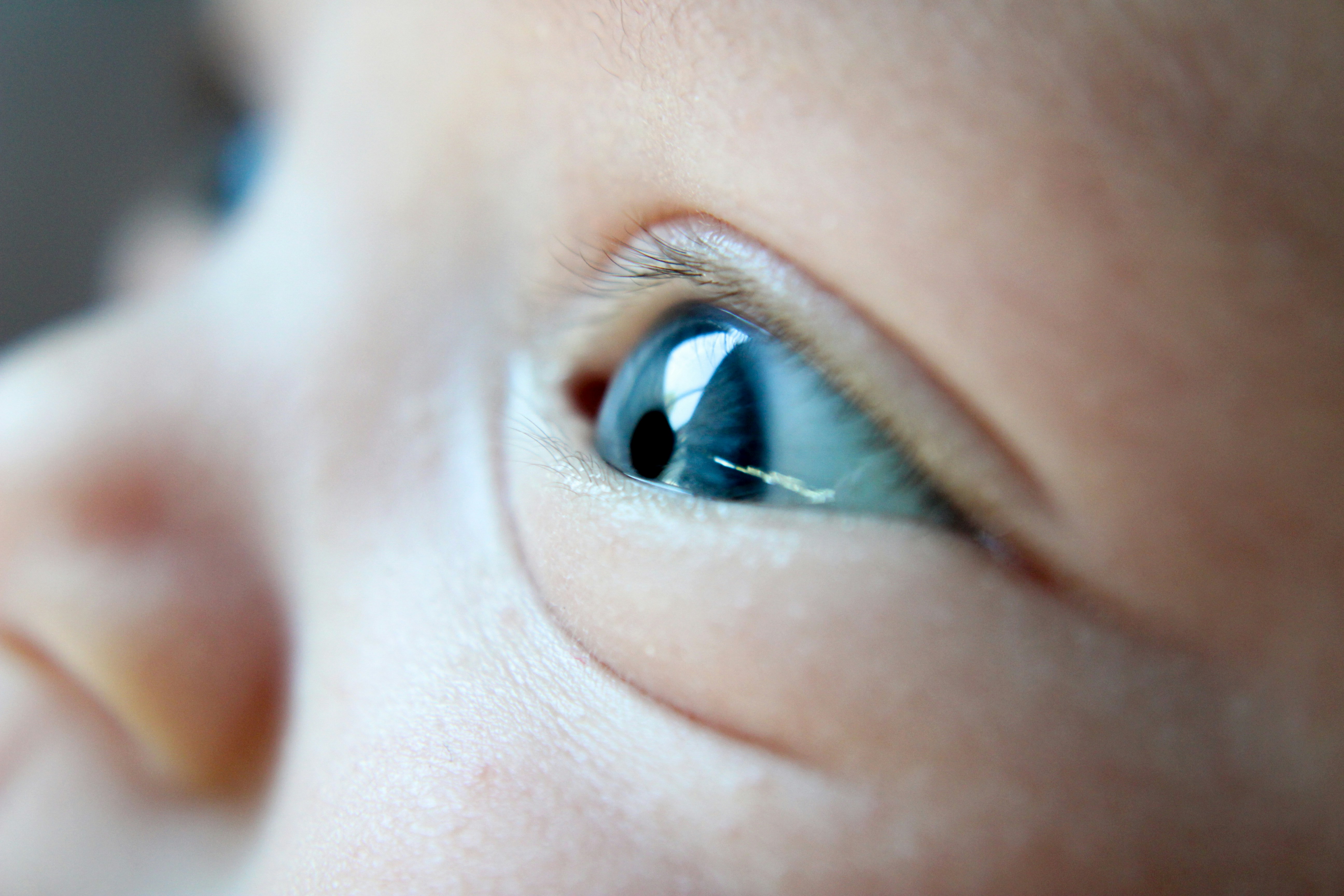 a close up of a baby's blue eyes