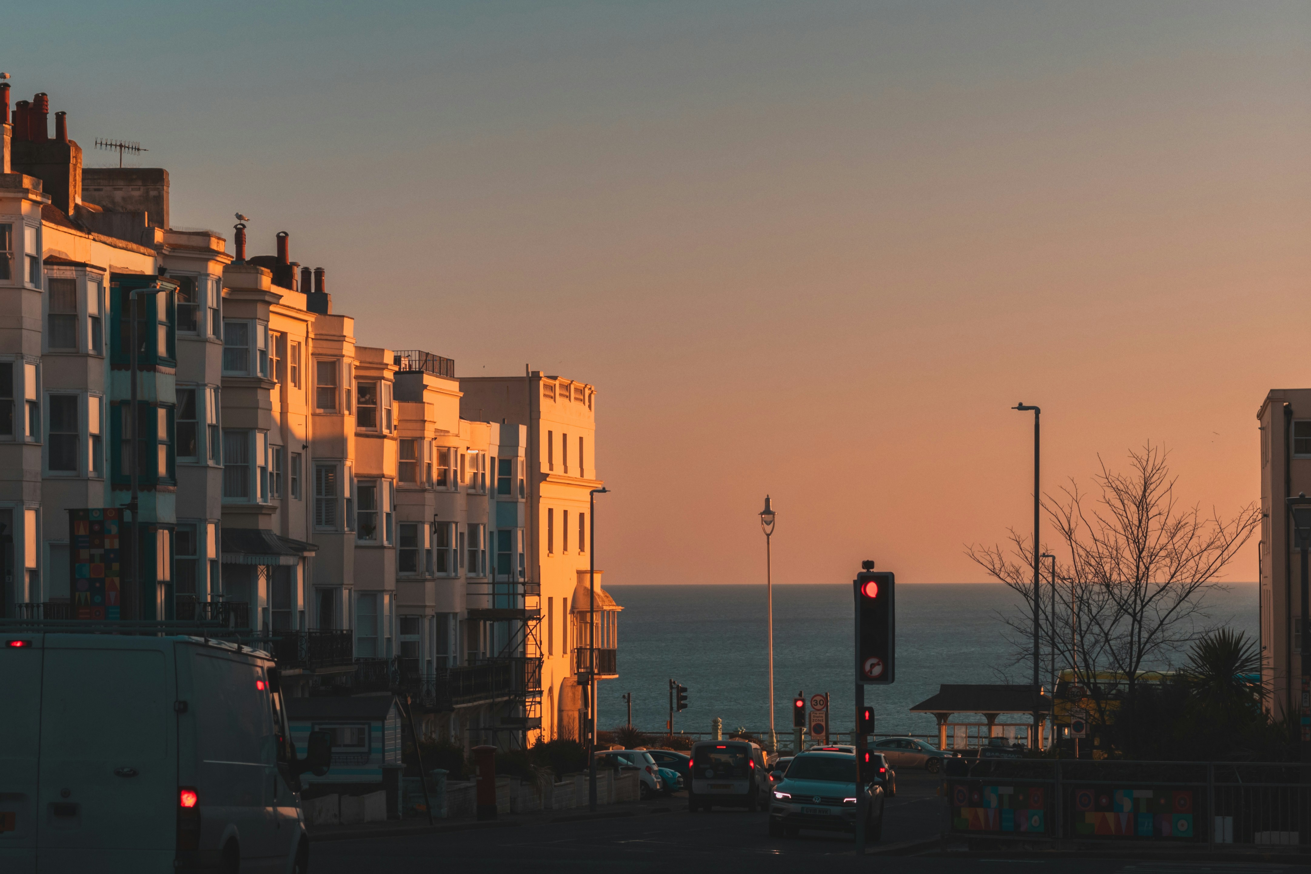 a traffic light on a city street next to a body of water