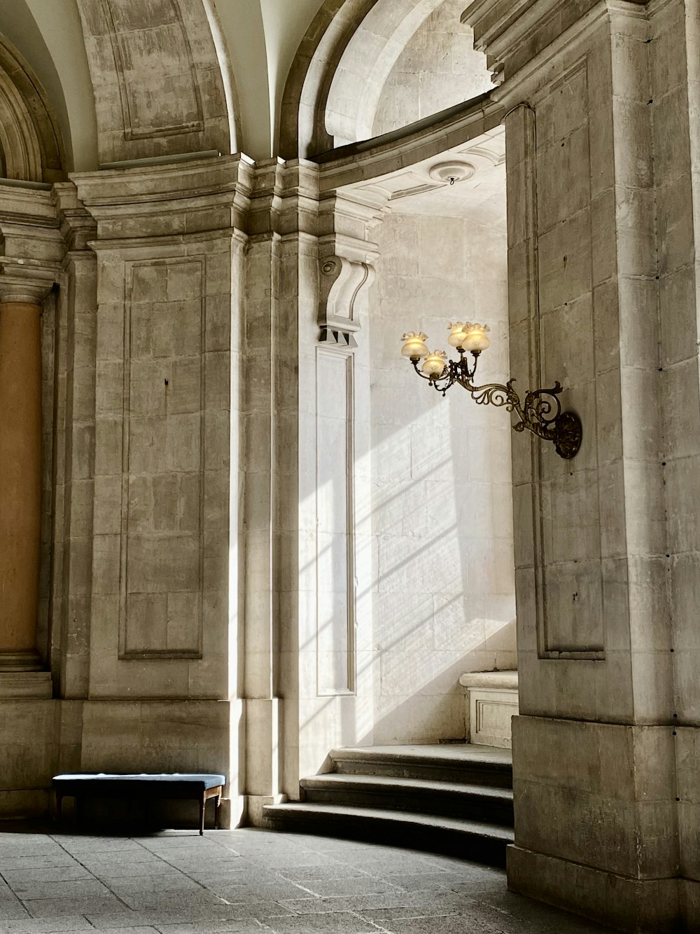 a room with a bunch of pillars and a light fixture