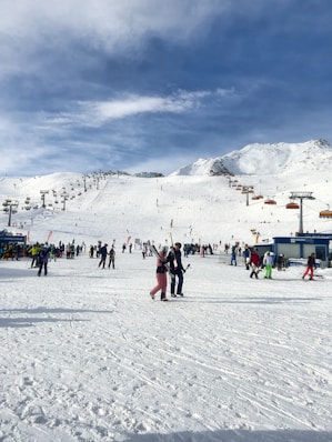 a group of people standing on top of a snow covered slope