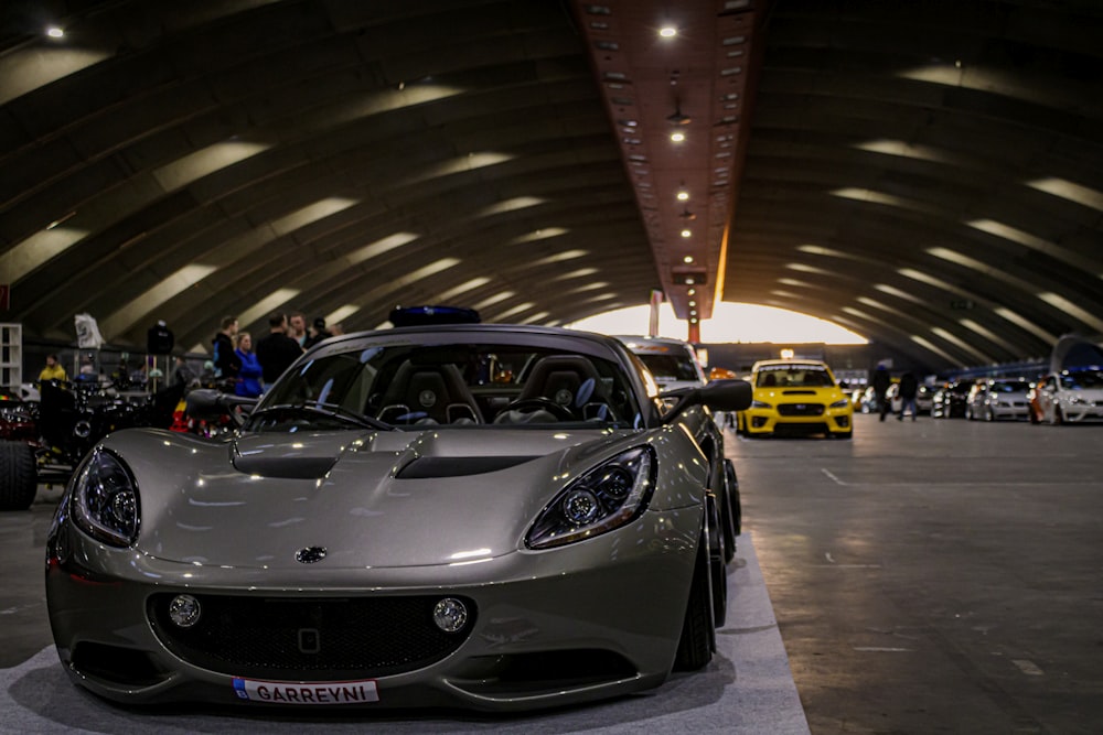 a silver sports car parked in a garage