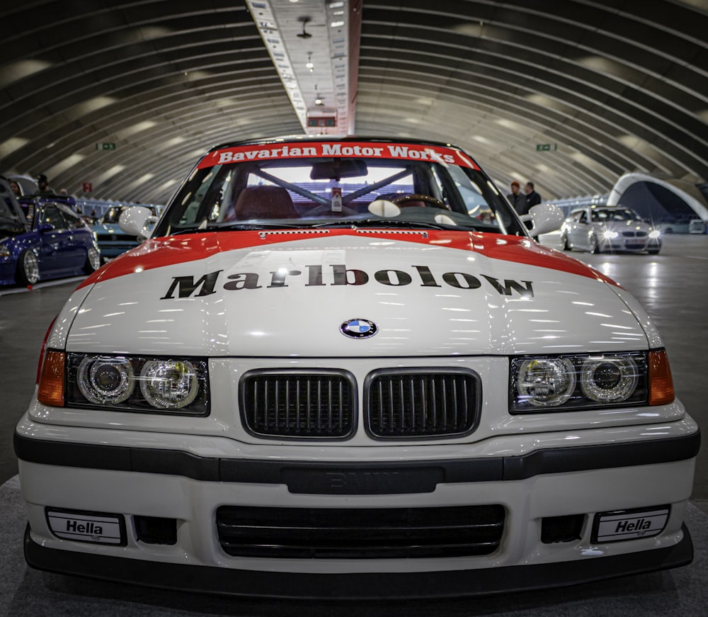 a white and red car parked in a tunnel