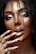 A close-up image of a person with wet hair cascading over their face, accentuating their flawless makeup and glossy lips. Long fingernails, painted in a nude color, touch the face softly while a few subtle jewelry pieces are visible on the hand.
