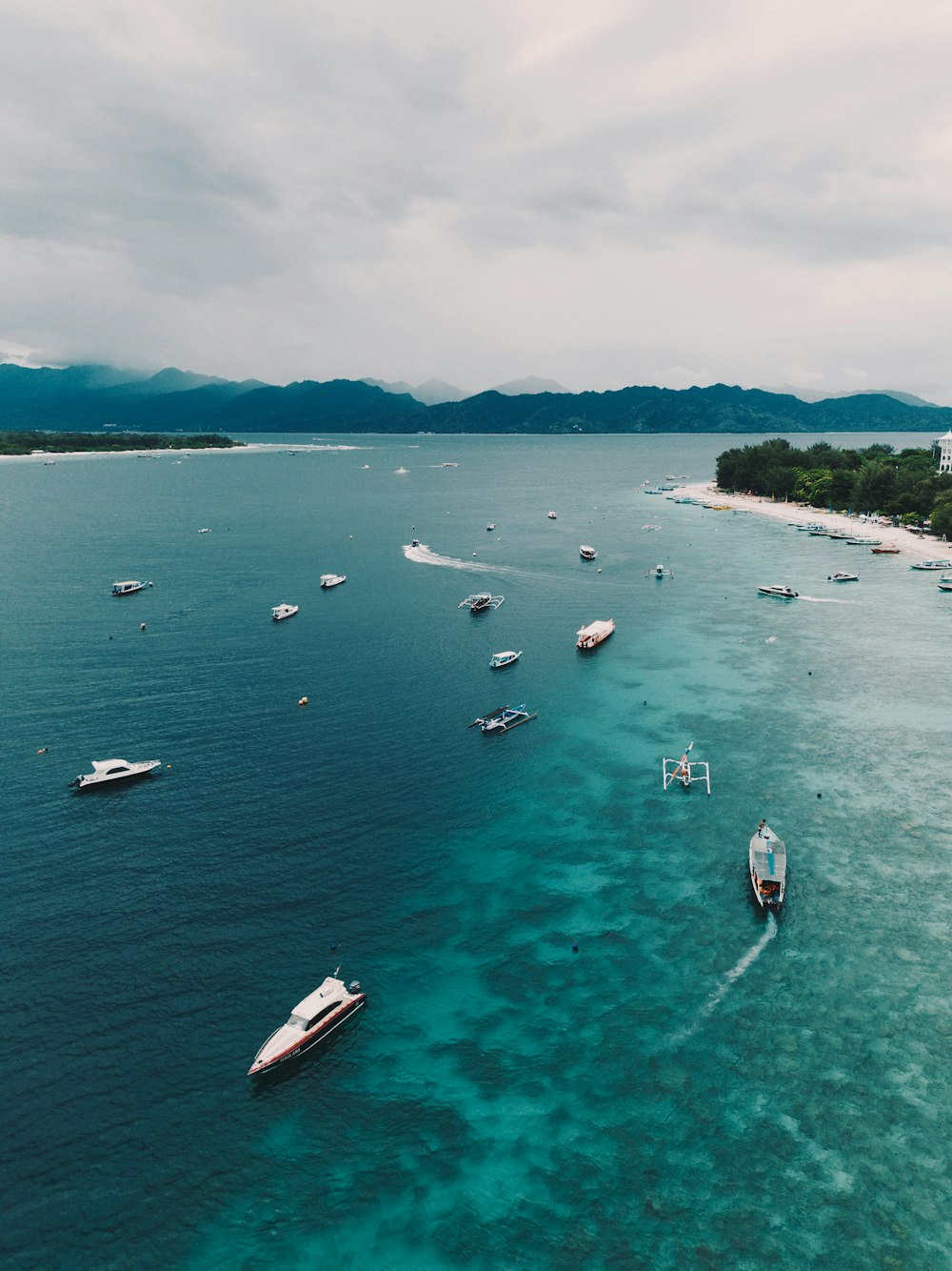 a group of boats floating on top of a body of water