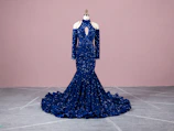 Mermaid gown hugging the figure, shown in deep navy blue with subtle shimmer.