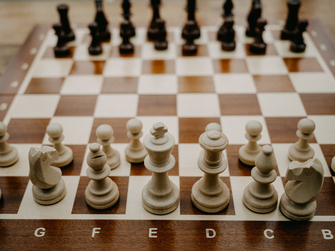 a close up of a chess board with pieces on it,