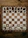 A wooden chessboard is set up with chess pieces in their starting positions. The board is placed on a rustic wooden table, and the chess pieces are made of wood, with darker pieces at the top and lighter pieces at the bottom.