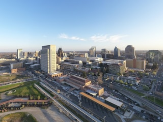 A panoramic view of a bustling Riyadh cityscape at sunset, highlighting modern infrastructure.