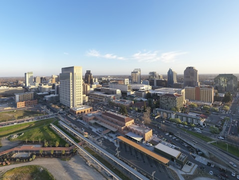A panoramic view of a bustling Riyadh cityscape at sunset, highlighting modern infrastructure.