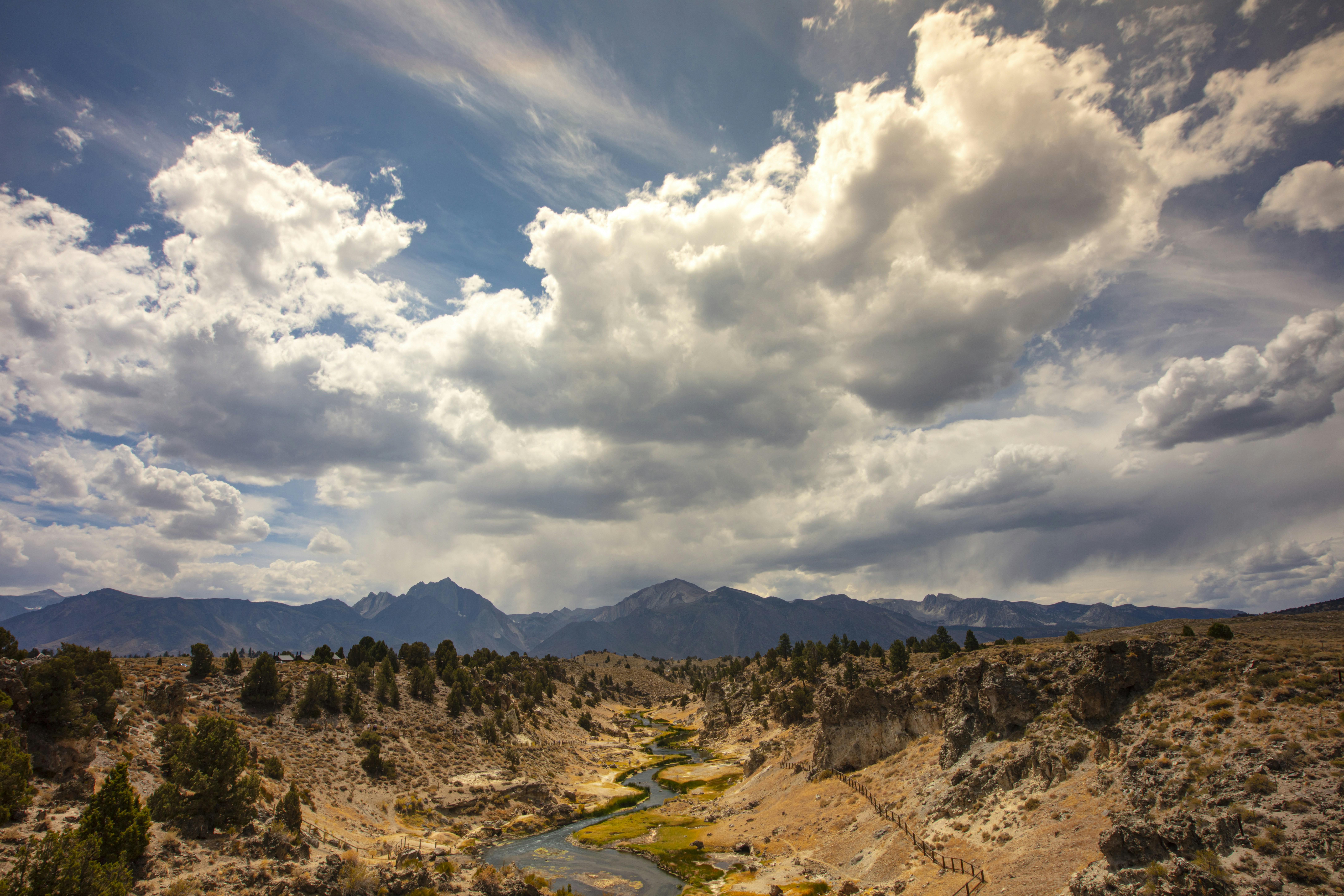 a river running through a valley surrounded by mountains