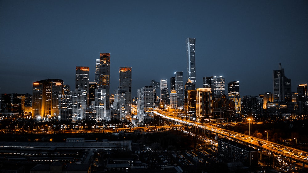 a city at night with a lot of tall buildings