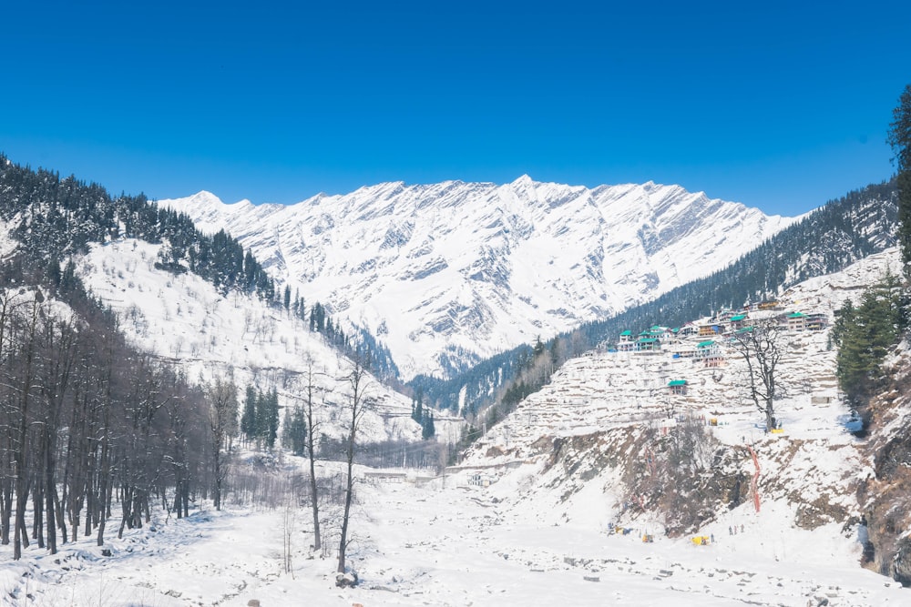 a snow covered mountain with a ski lift in the distance