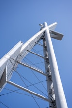 Sleek steel structure under construction against a clear sky.