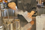 Ice maker component being serviced by a technician in a modern home setting.