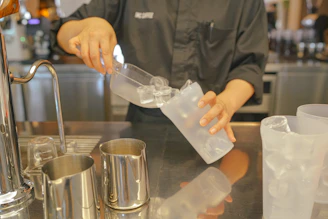 An ice machine dispensing fresh ice cubes with a stainless steel finish.