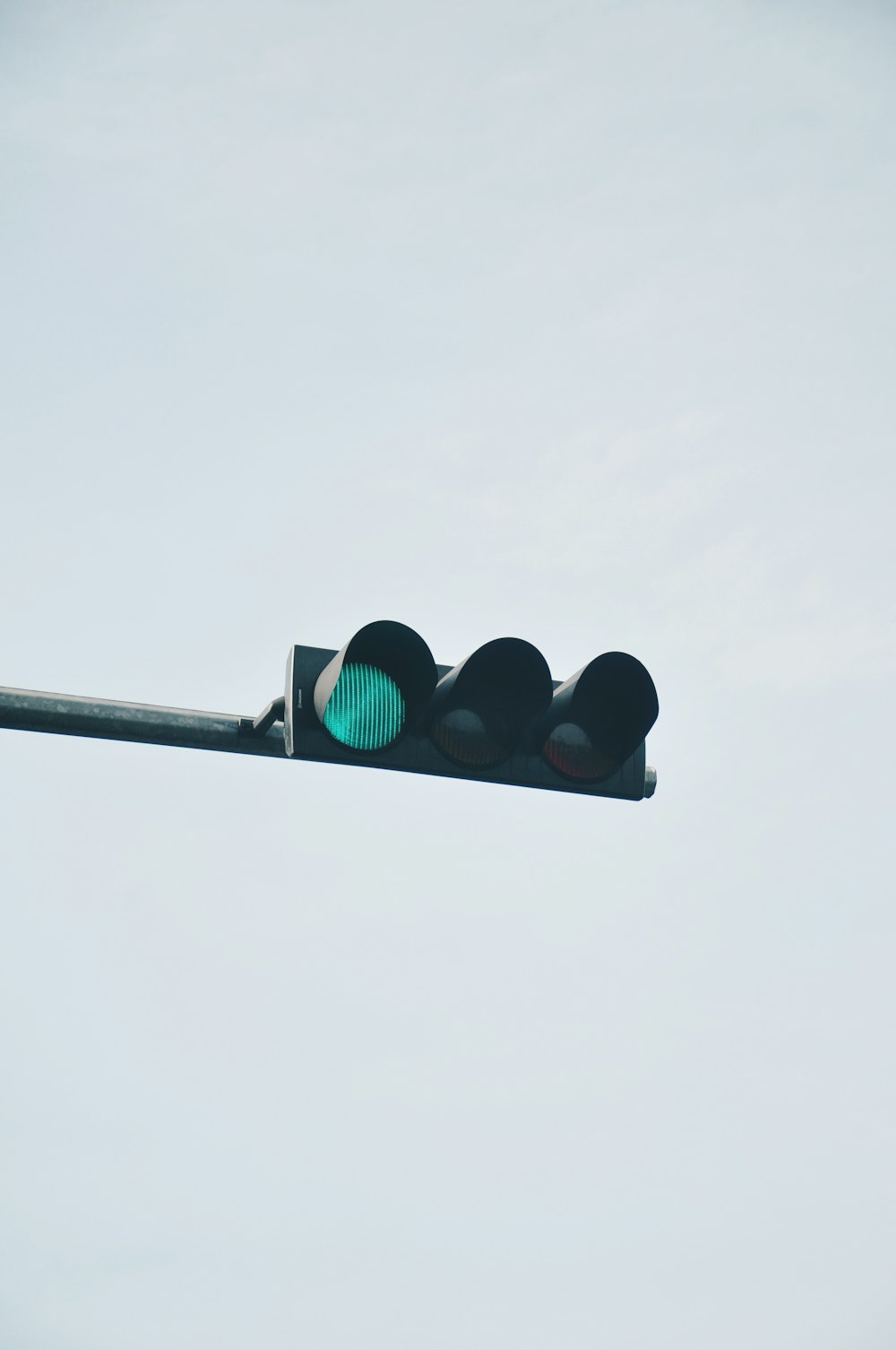 a traffic light that is green on a pole
