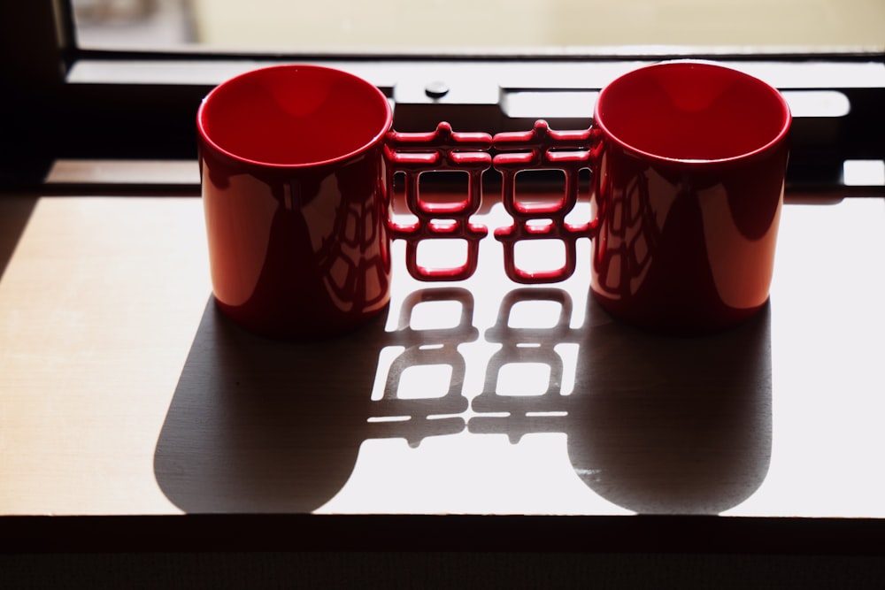 a couple of red cups sitting on top of a table