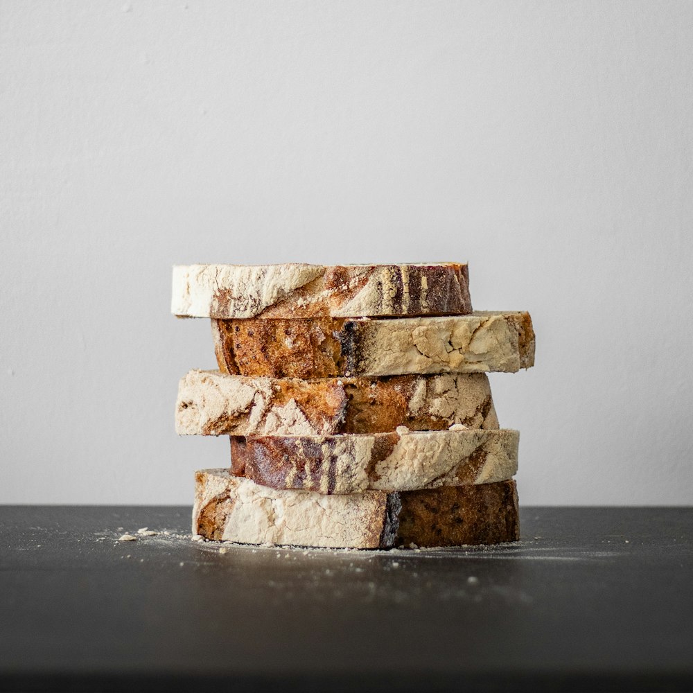 a stack of four pieces of bread sitting on top of a table