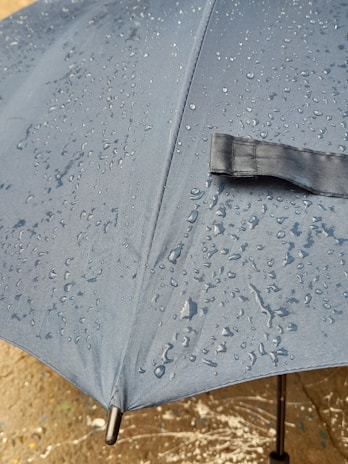 Close-up of a durable tent fabric with rain droplets on it, highlighting quality.