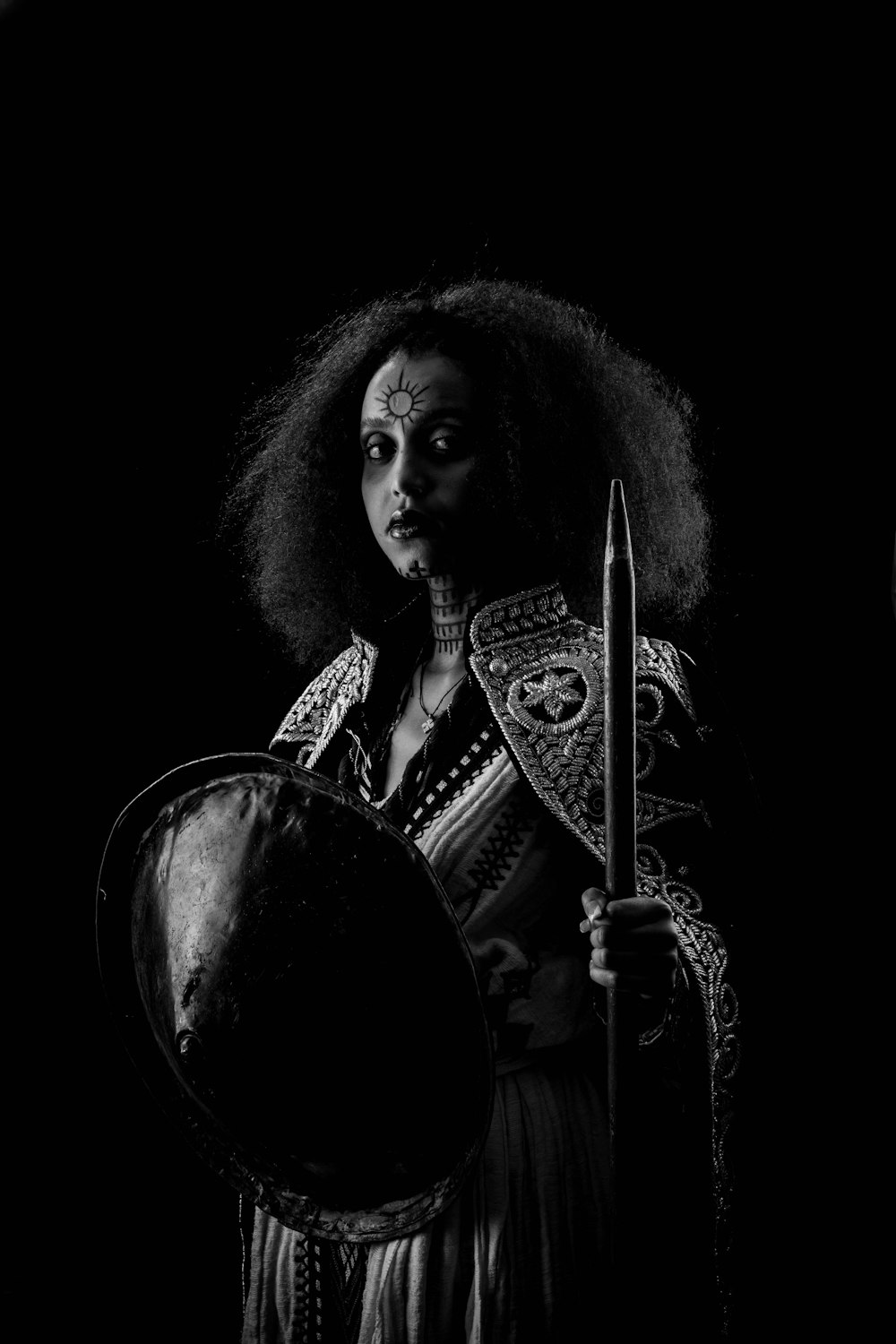 a woman in a costume holding a sword and a shield