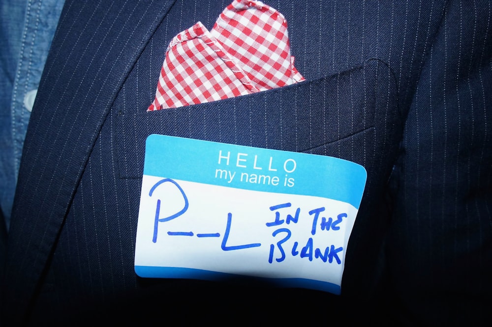 a close up of a person wearing a suit and tie