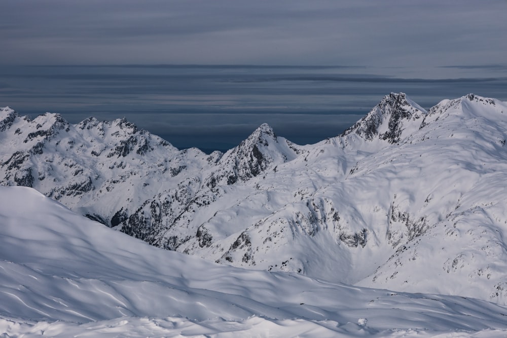 a man riding skis on top of a snow covered slope