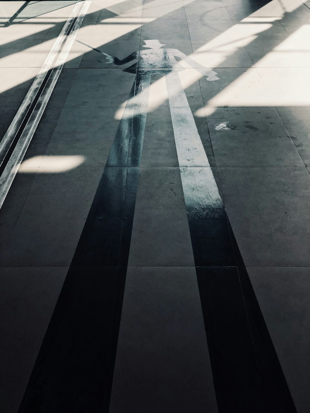 a black and white photo of a person walking down a street