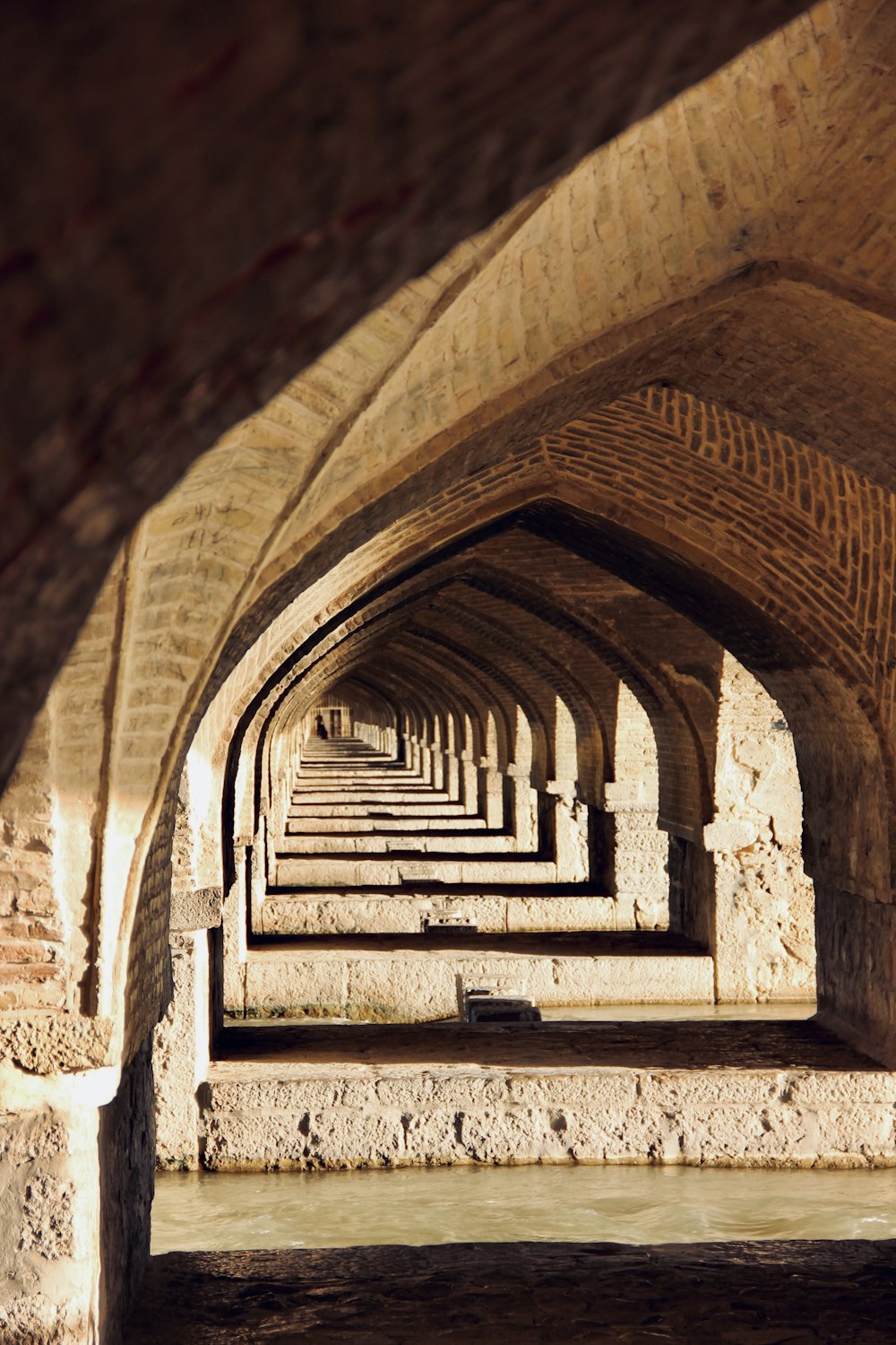 a row of benches in a stone tunnel