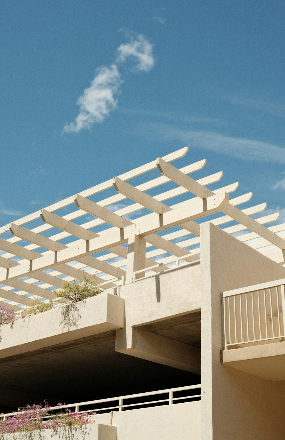 a white building with a wooden roof and a balcony