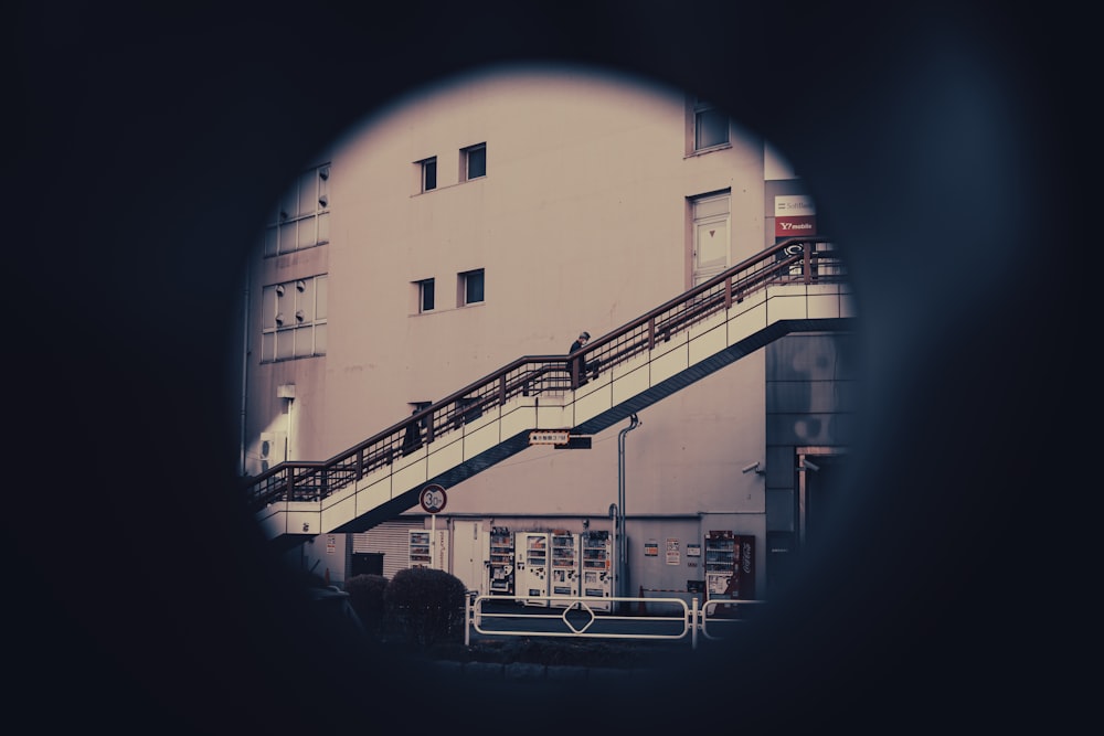 a view of a building through a hole in the wall