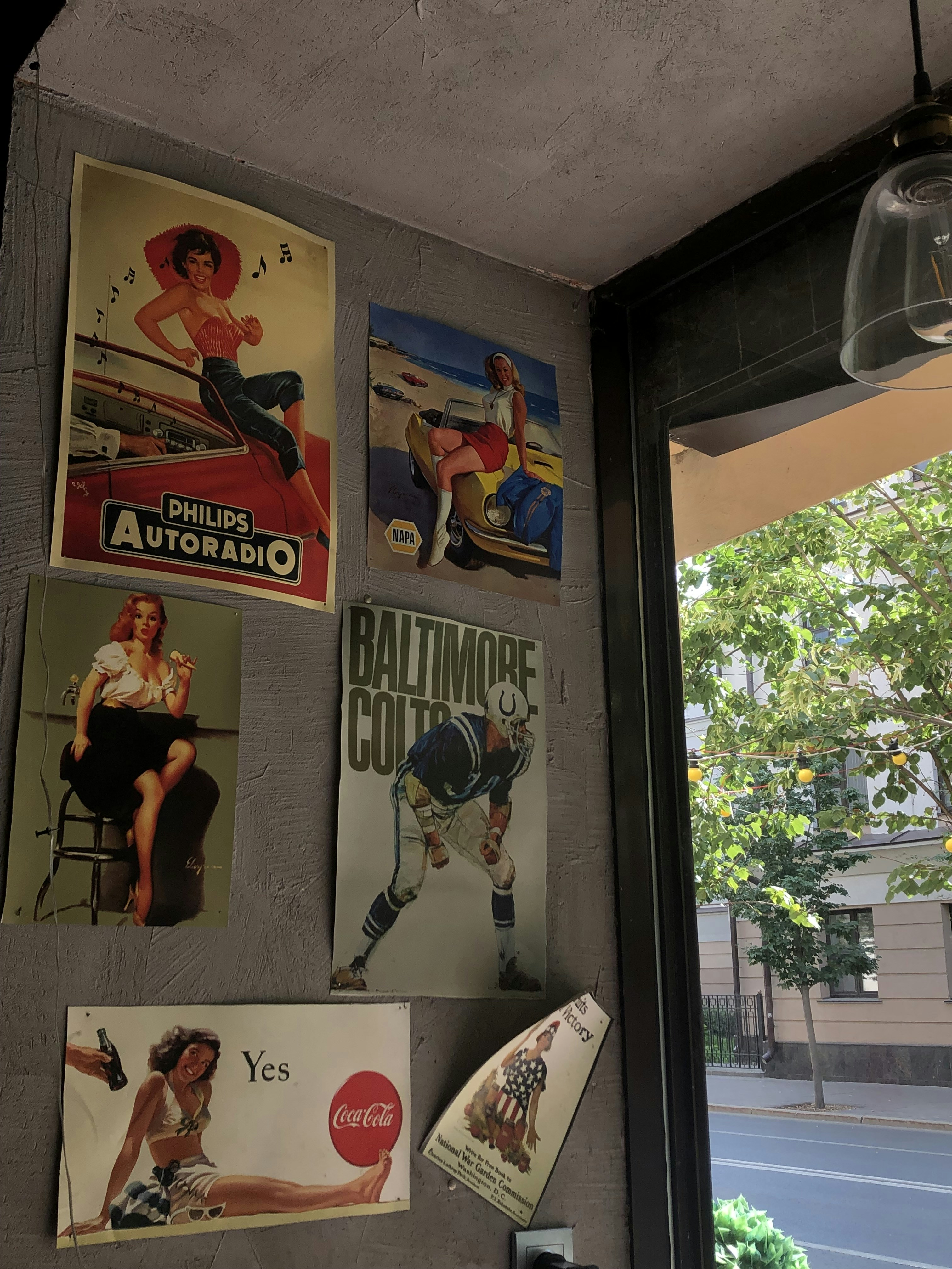 a bunch of posters are hanging on a wall