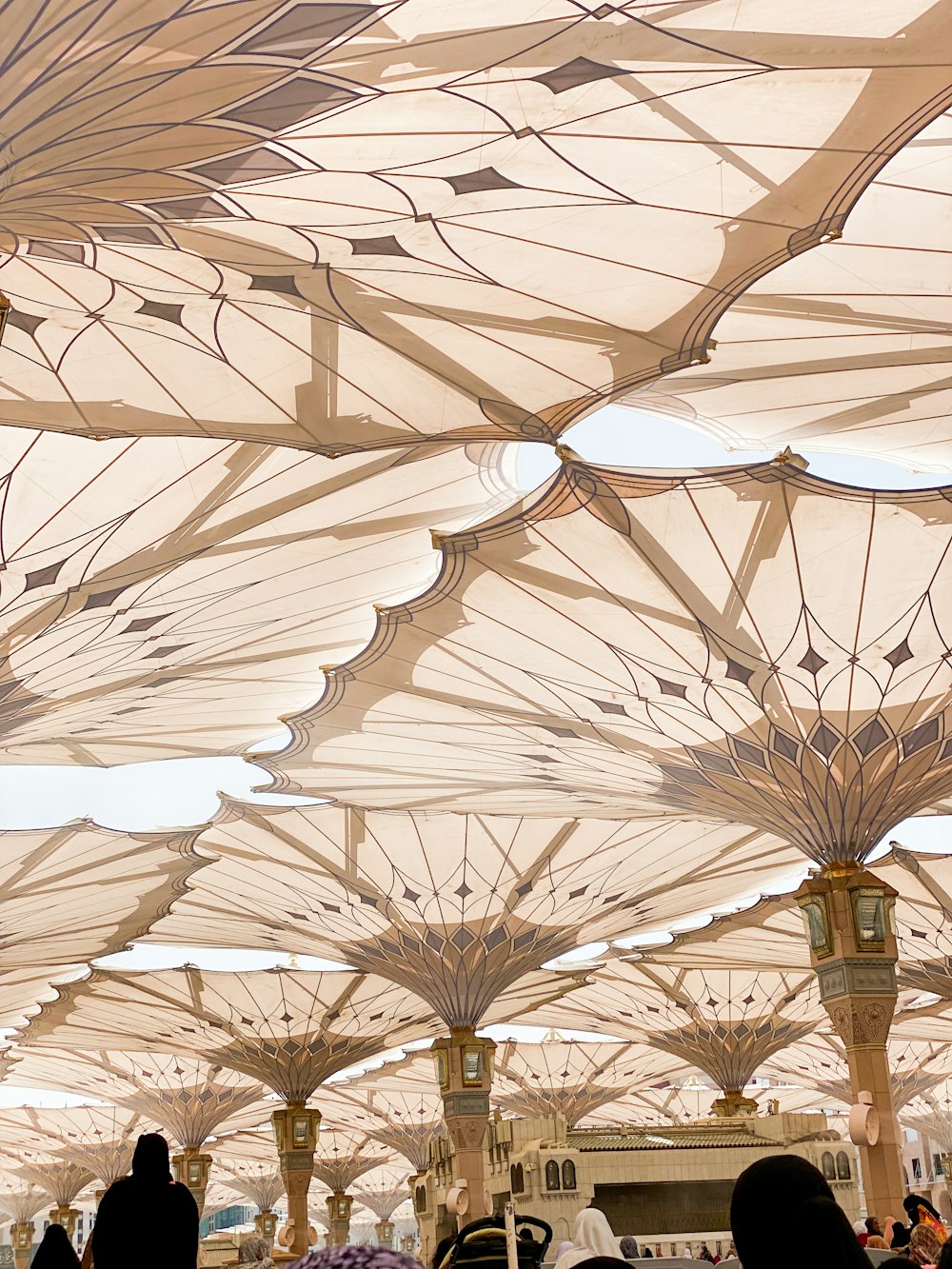 a group of people standing under umbrellas in a building