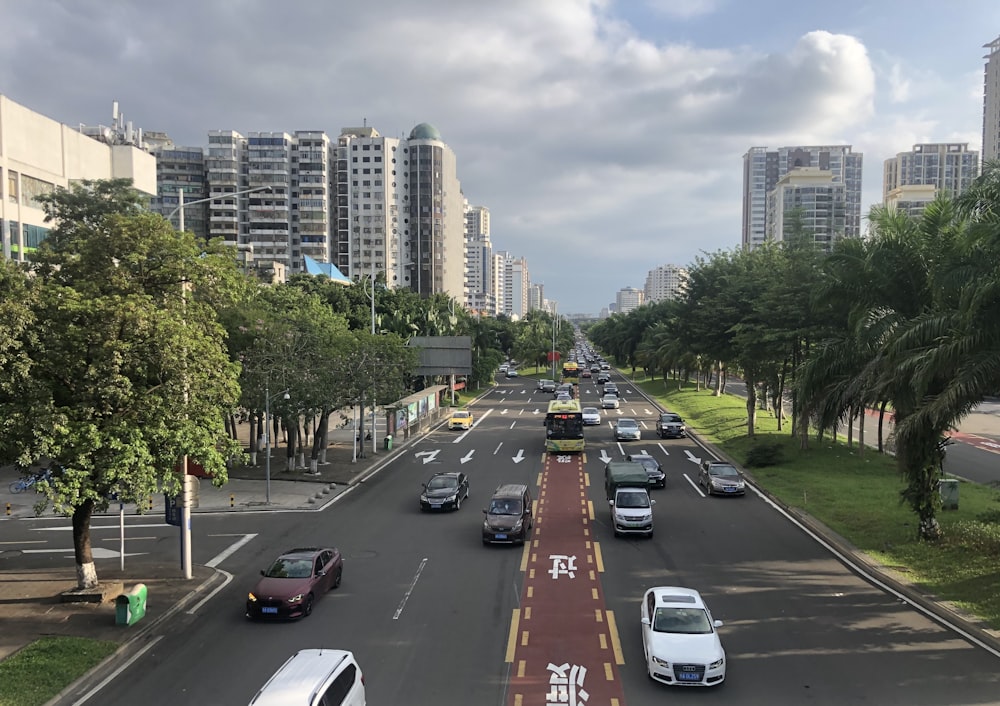 a city street filled with lots of traffic next to tall buildings