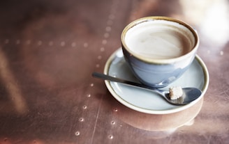 A close-up of a copper-accented coffee cup resting on a blueprint, blending the worlds of construction and caffeine.
