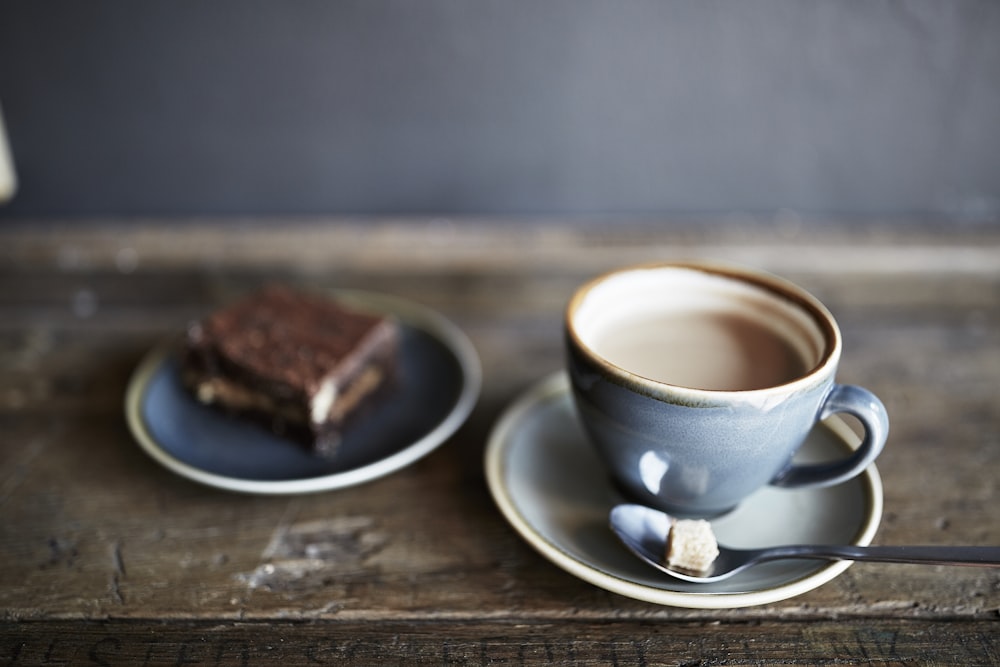 a cup of coffee and a piece of cake on a table