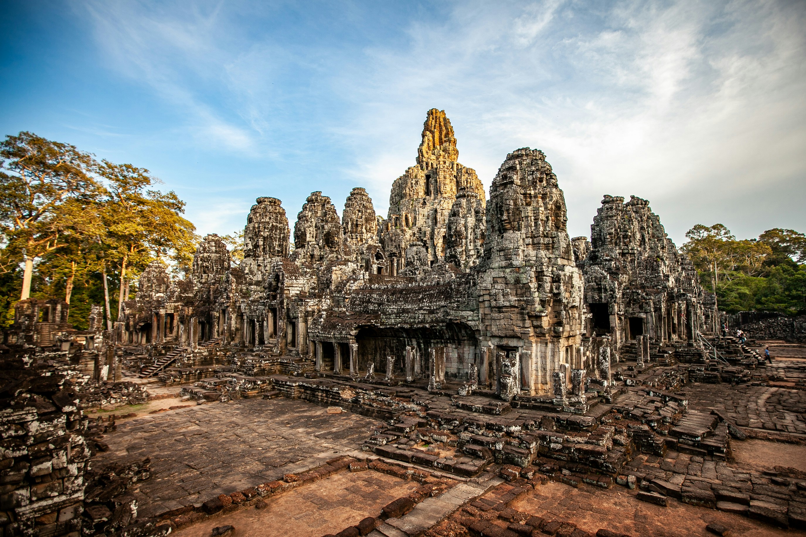a large group of stone buildings surrounded by trees, 