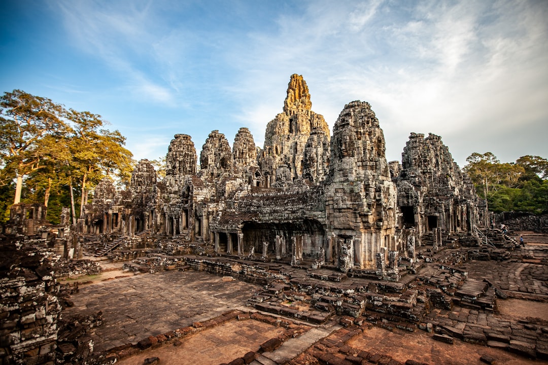 a large group of stone buildings surrounded by trees,