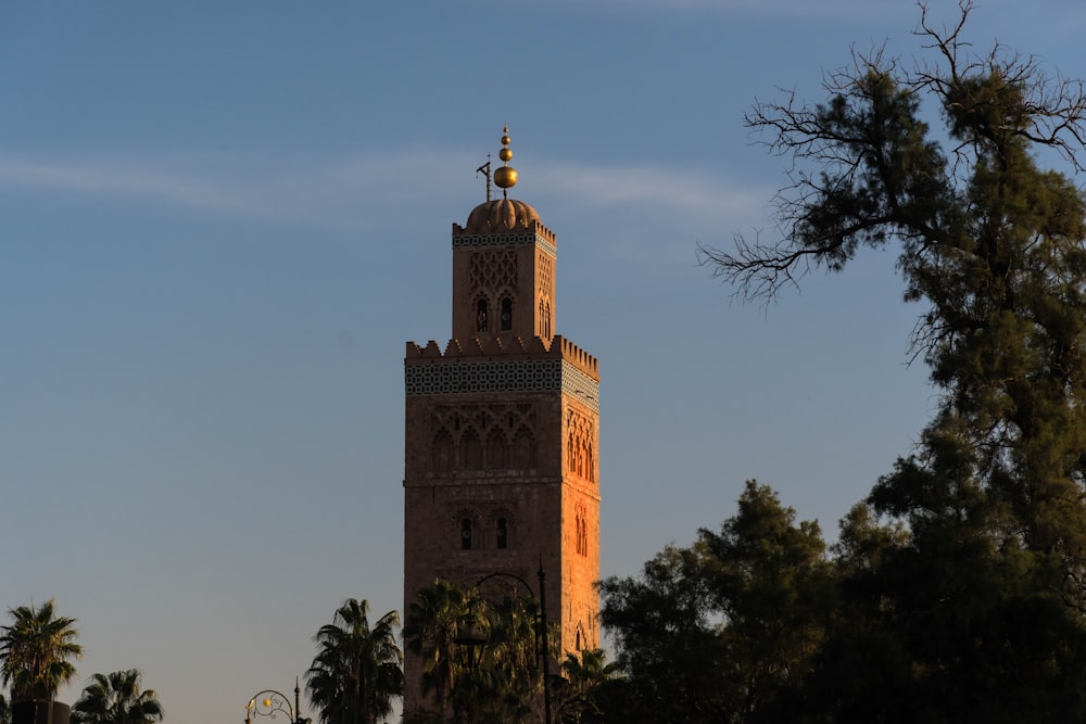 a tall tower with a cross on top of it