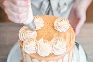 a person cutting a cake with a knife